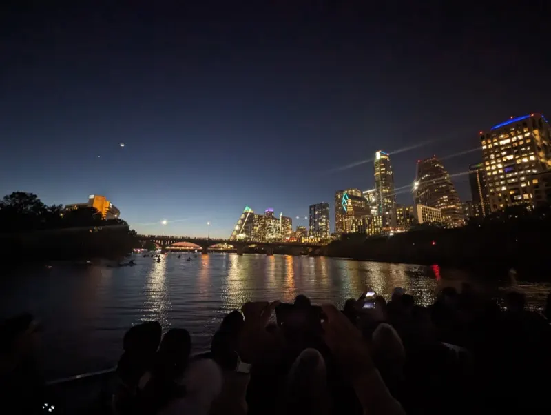 A city skyline reflected in water at night